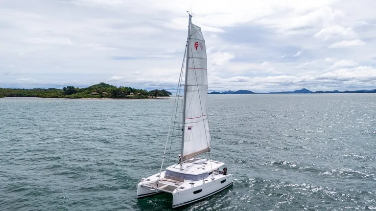 Fountaine Pajot Astrea 42 — sailing off an island